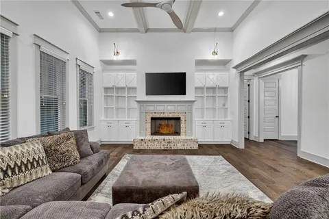 a spacious bathroom with a granite countertop double vanity sink a mirror and a bathtub