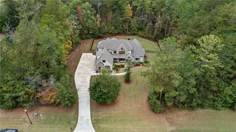 an aerial view of a house with outdoor space swimming pool and lake view