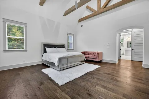 a room with a bed and a wooden floor