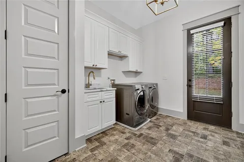 a bathroom with a granite countertop toilet and sink