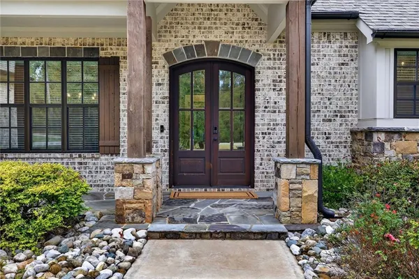a open kitchen with stainless steel appliances granite countertop a refrigerator oven a sink dishwasher and white cabinets with wooden floor