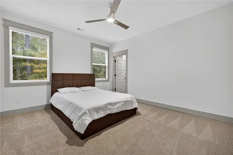 an aerial view of residential houses with outdoor space and trees
