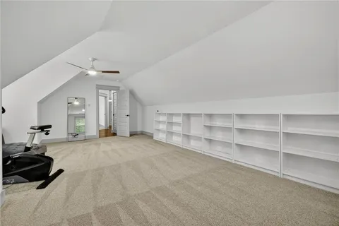 an aerial view of a house with a yard and lake view