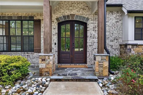 a view of a hallway with wooden floor and a potted plant