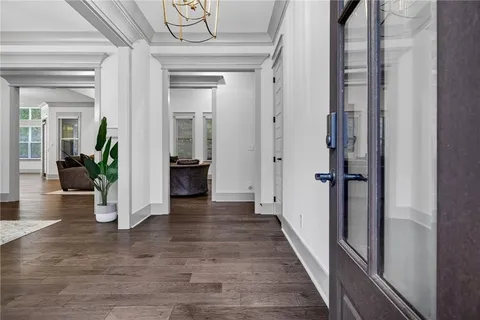 a open kitchen with stainless steel appliances granite countertop a refrigerator oven a sink dishwasher and white cabinets with wooden floor