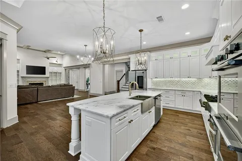 a kitchen with a sink stainless steel appliances and cabinets