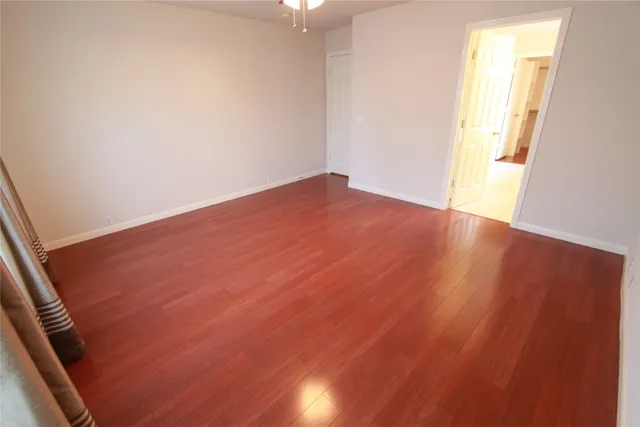 an empty room with wooden floor