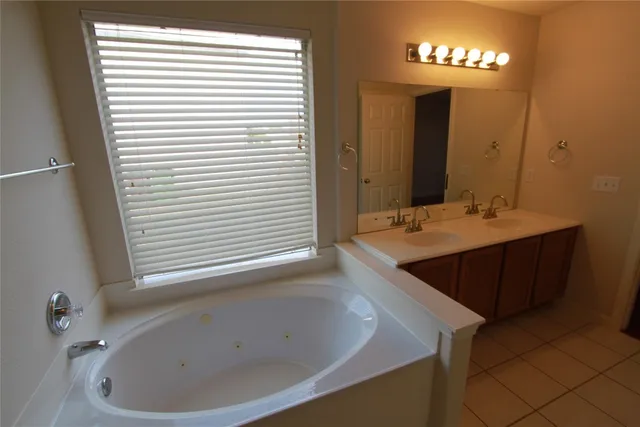 a bathroom with a bathtub and a sink