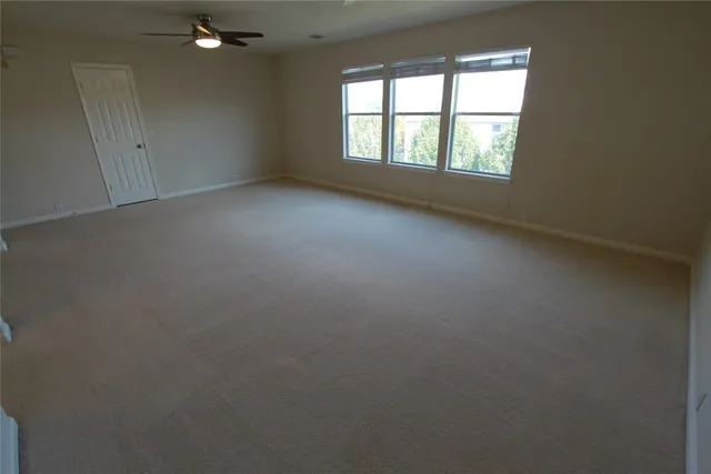 an empty room with windows and entrance