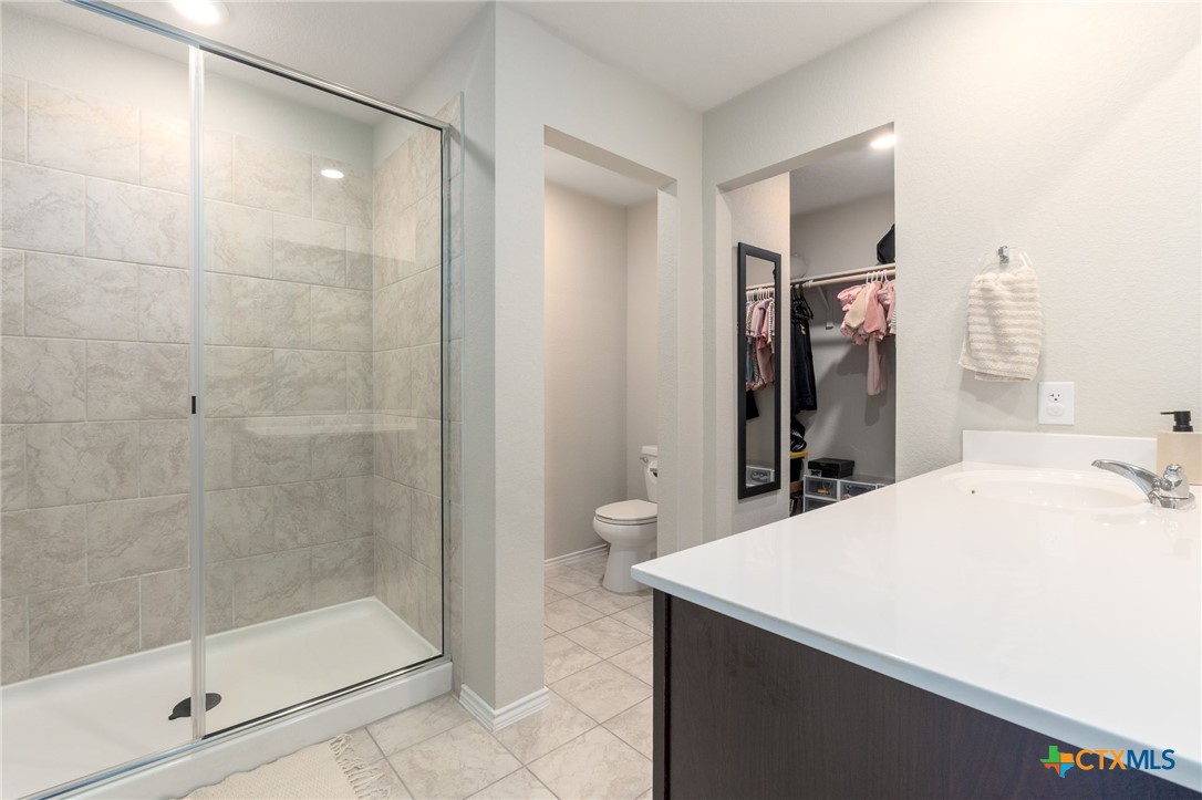 5105 Natalia Road Killeen, TX 76549 - Photo 13 of 15 a bathroom with a shower and a sink a mirror