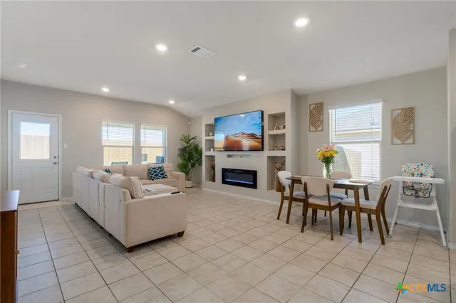a living room with fireplace furniture and a wooden floor