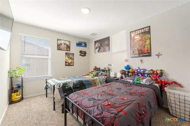 a bed sitting in a bedroom next to a window