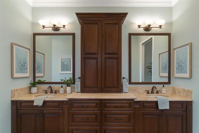 a living room with furniture a kitchen island with fireplace furniture and a large window
