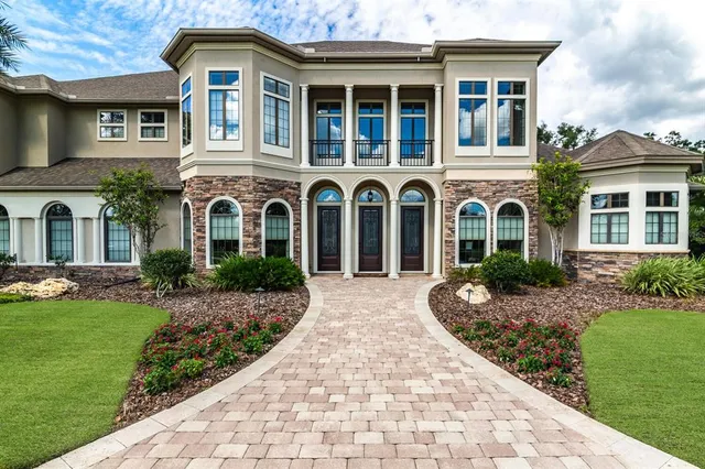 a front view of a house with a yard table and chairs