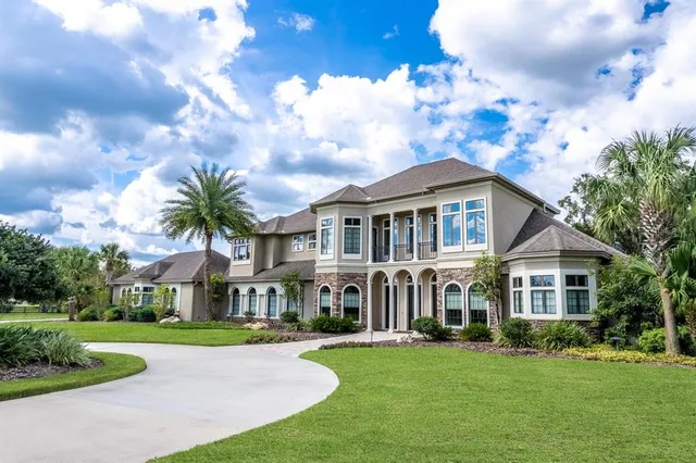 a view of yard with swimming pool and green space