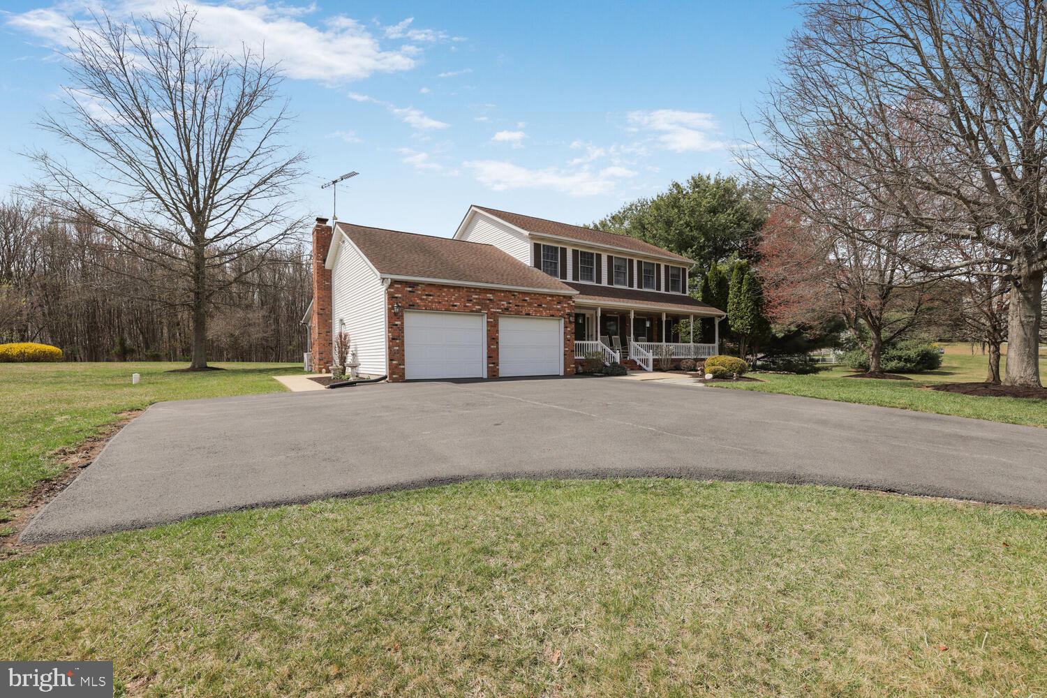 1050 Huntfield Road Westminster, MD 21157 - Photo 2 of 38 a front view of a house with a yard and trees
