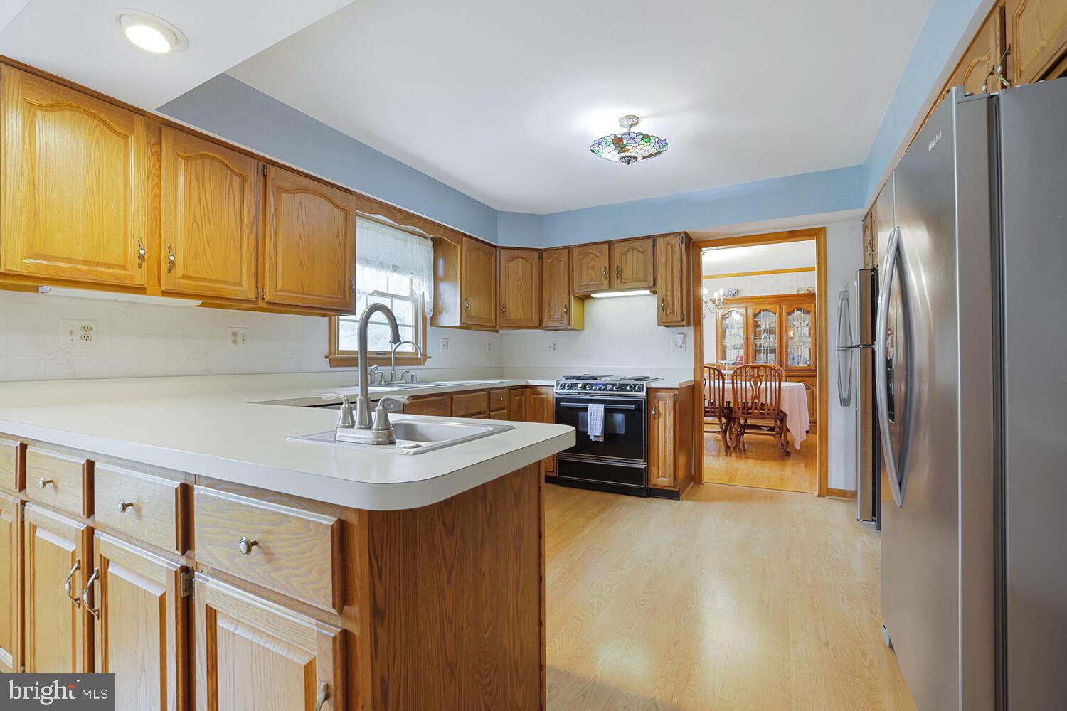 1050 Huntfield Road Westminster, MD 21157 - Photo 7 of 38 a kitchen with stainless steel appliances granite countertop a sink refrigerator and cabinets