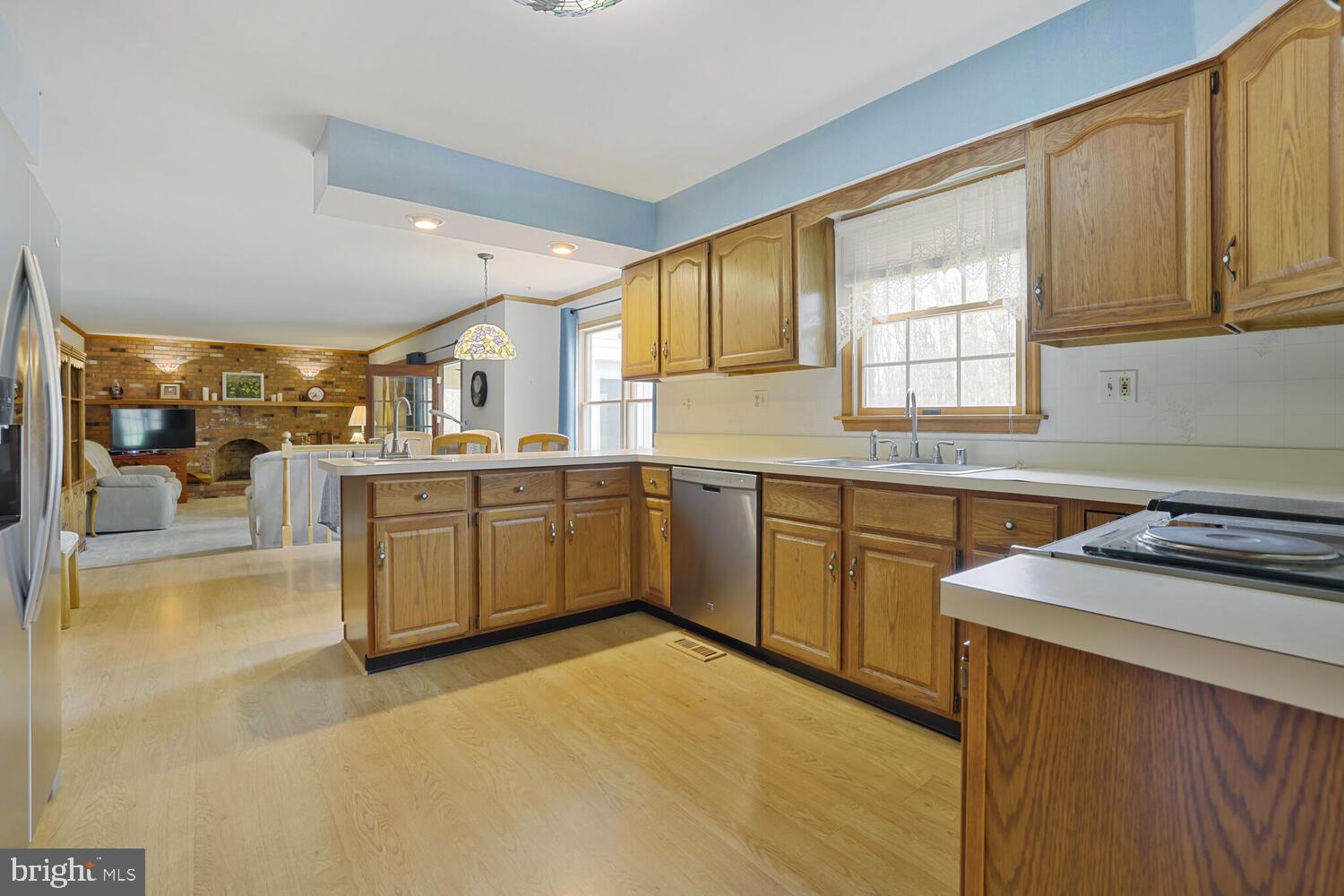 1050 Huntfield Road Westminster, MD 21157 - Photo 8 of 38 a kitchen with a sink stove and cabinets