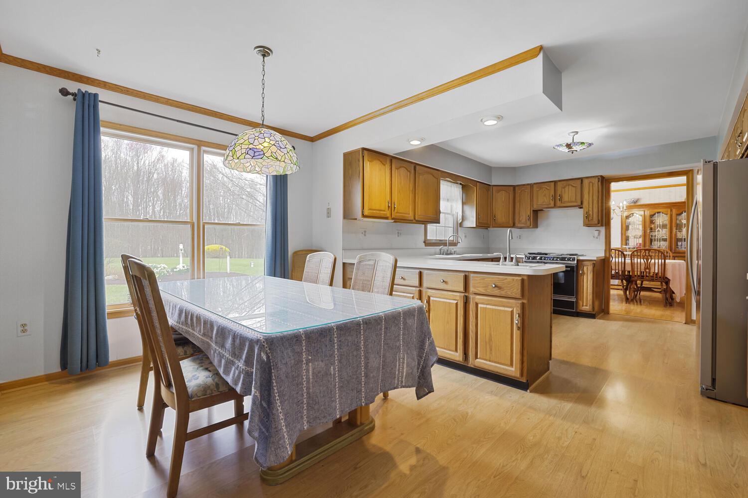 1050 Huntfield Road Westminster, MD 21157 - Photo 9 of 38 a kitchen with a table chairs sink and cabinets
