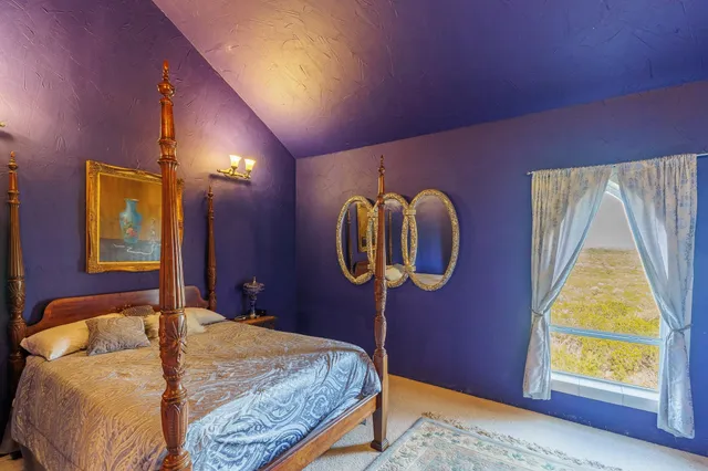 a view of a bedroom with furniture and staircase