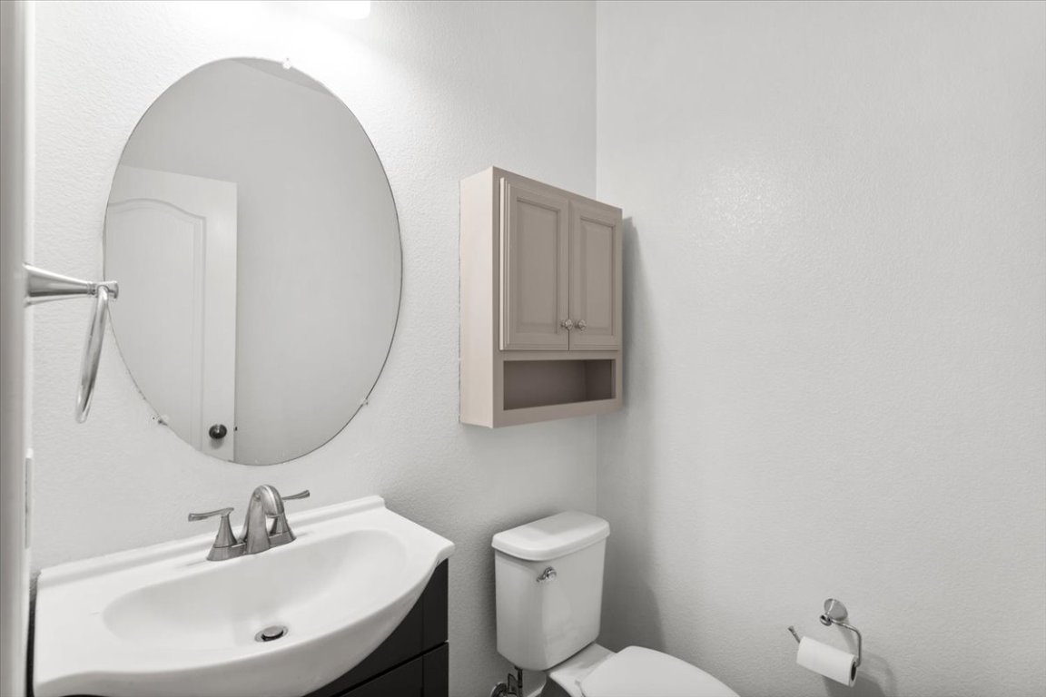 3702 Tall Cedars Road Cedar Park, TX 78613 - Photo 14 of 34 a bathroom with a toilet a sink and mirror