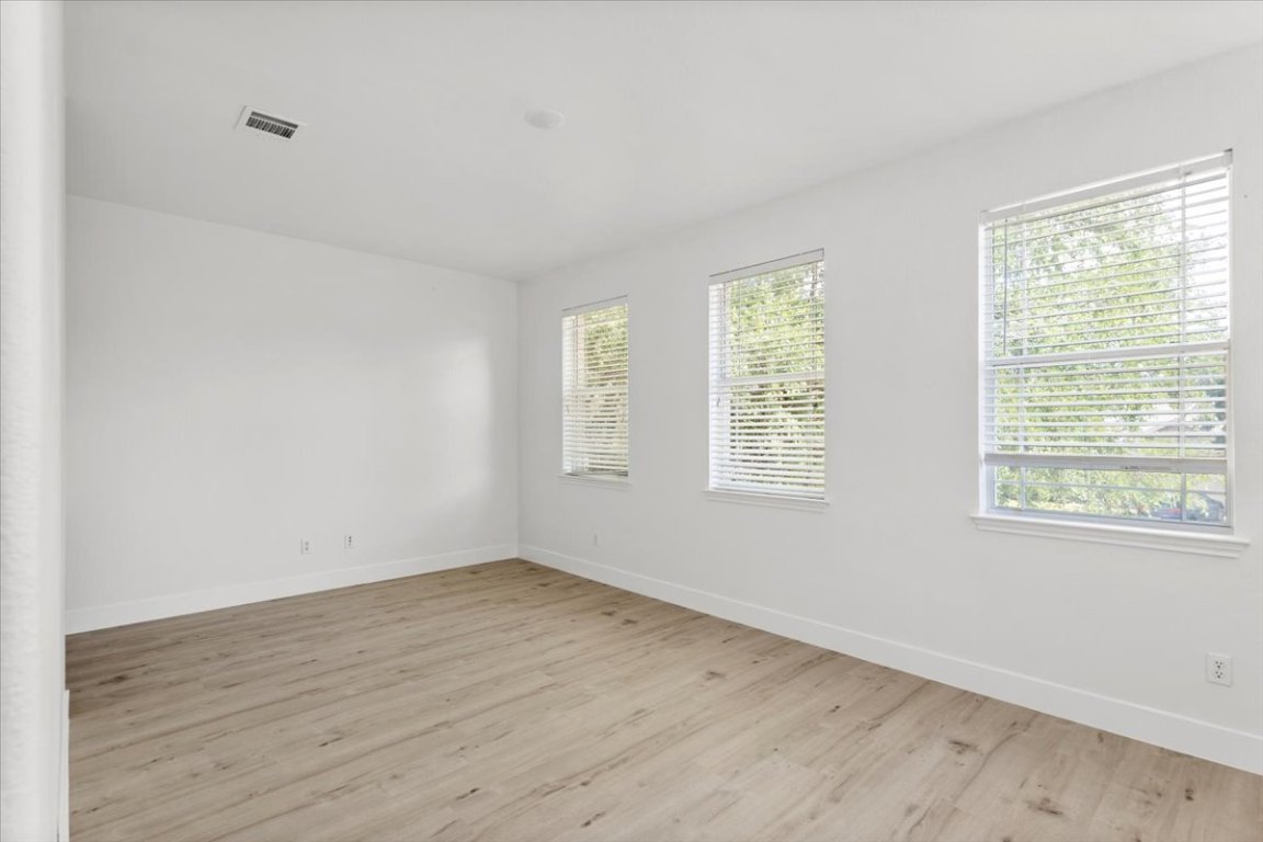 3702 Tall Cedars Road Cedar Park, TX 78613 - Photo 15 of 34 a view of a room with wooden floor and windows in it