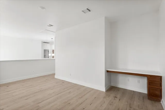 an empty room with wooden floor