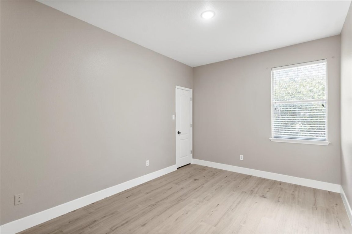 3702 Tall Cedars Road Cedar Park, TX 78613 - Photo 20 of 34 wooden floor in an empty room with a window