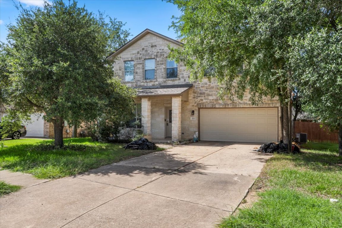 3702 Tall Cedars Road Cedar Park, TX 78613 - Photo 2 of 34 a front view of a house with a garden and trees