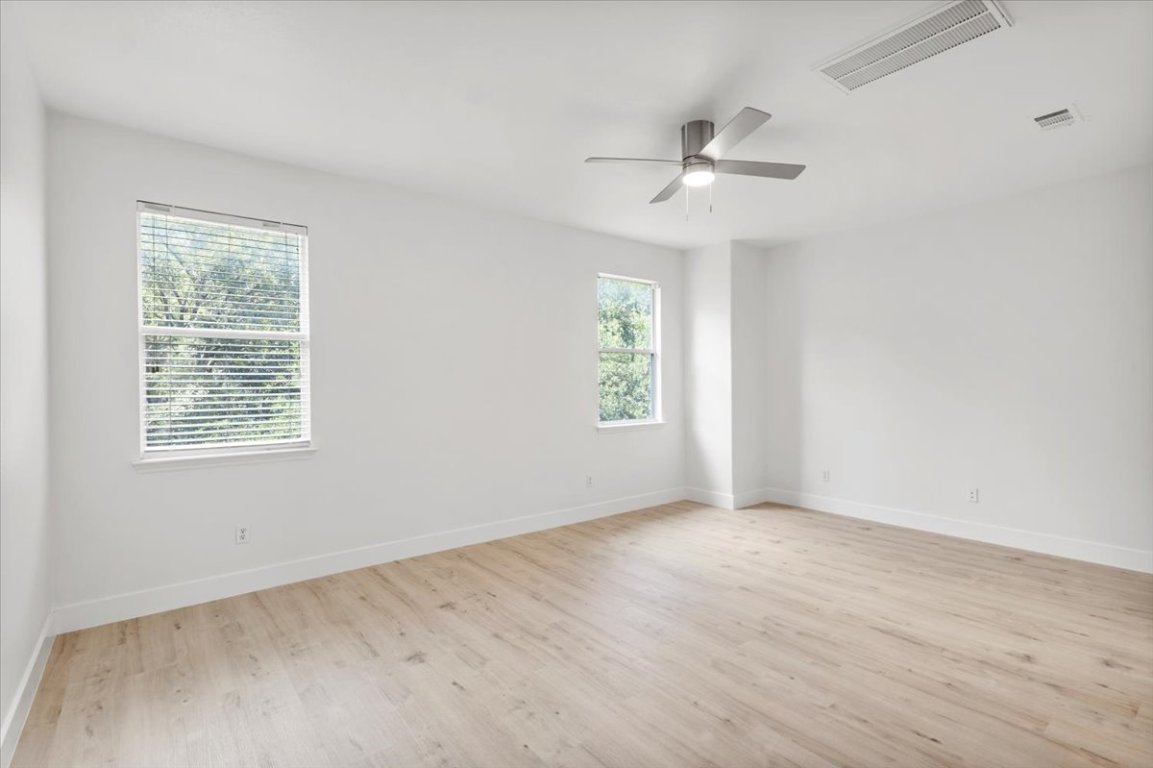 3702 Tall Cedars Road Cedar Park, TX 78613 - Photo 25 of 34 an empty room with windows and ceiling fan
