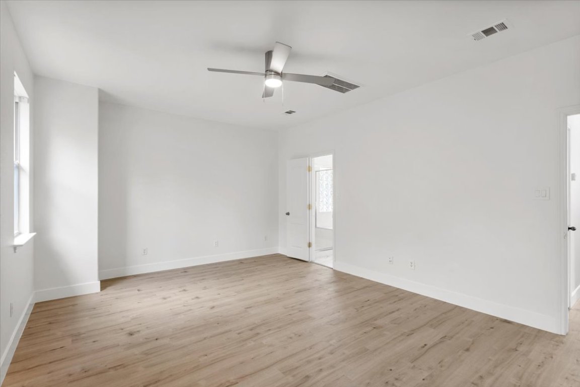 3702 Tall Cedars Road Cedar Park, TX 78613 - Photo 26 of 34 an empty room with wooden floor and ceiling fan