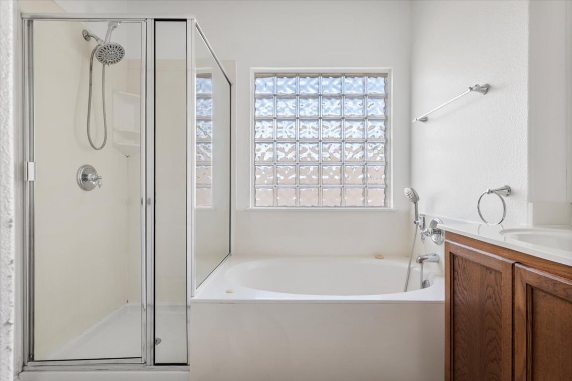 3702 Tall Cedars Road Cedar Park, TX 78613 - Photo 28 of 34 a bathroom with a bathtub a shower and a sink