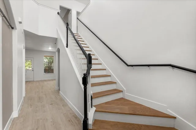 a view of entryway and hall with wooden floor