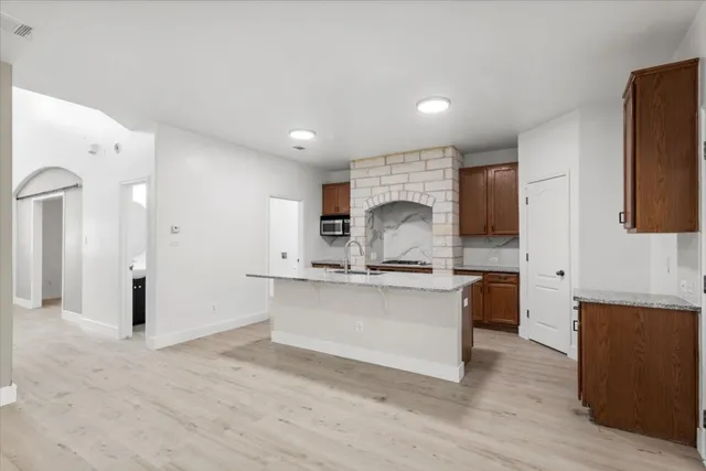a kitchen with stainless steel appliances a sink stove and cabinets