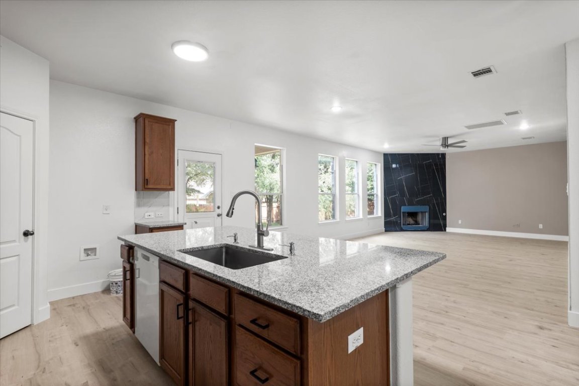3702 Tall Cedars Road Cedar Park, TX 78613 - Photo 10 of 34 a kitchen with granite countertop a sink and cabinets