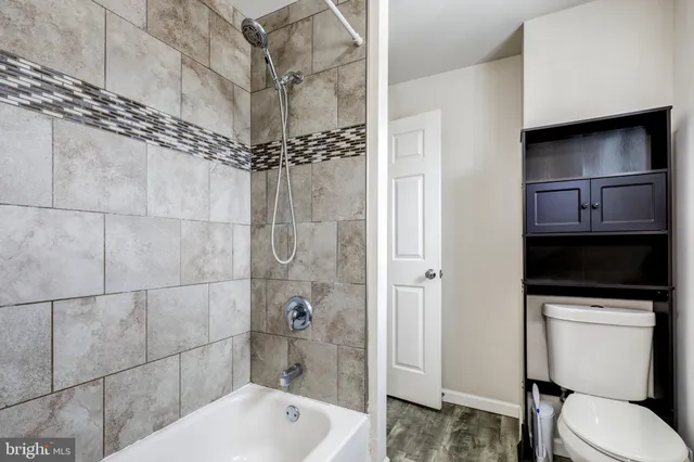 a bathroom with a toilet a sink and shower