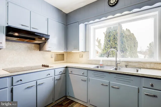 a kitchen with a sink cabinets and window