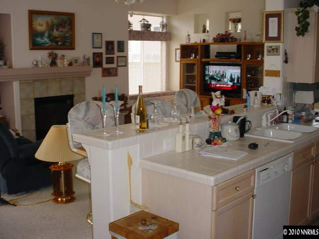 1130 Broadview Court Reno, NV 89521 - Photo 5 of 6 a kitchen with kitchen island granite countertop a sink cabinets and a stove