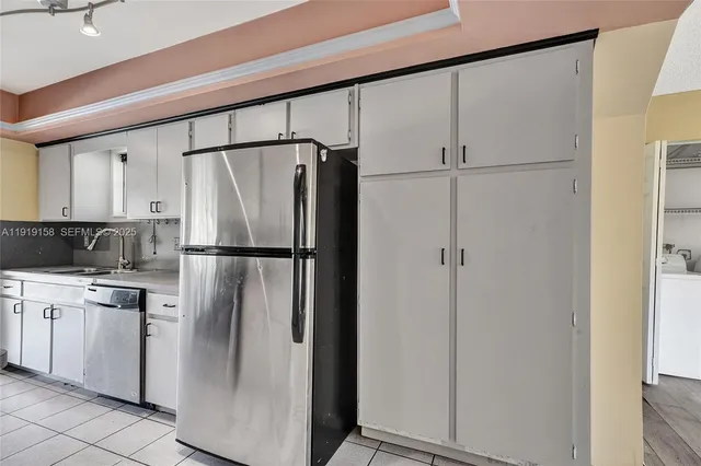 a kitchen with a sink cabinets and window