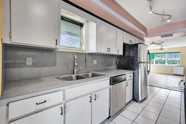 a view of an empty room with window and cabinet