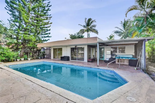 a living room with a large window and furniture