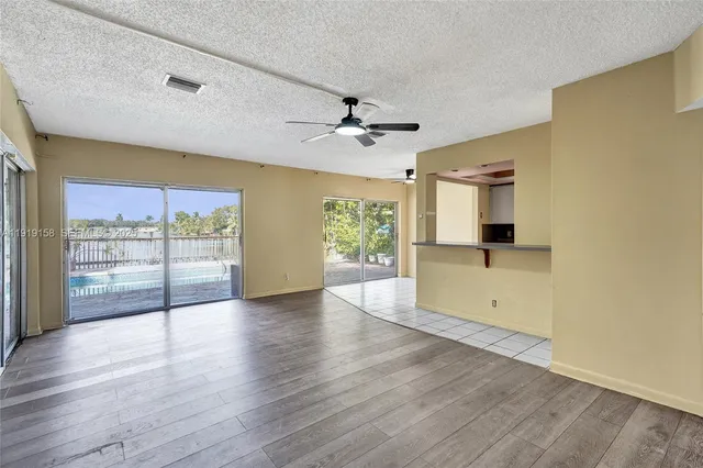 a kitchen with stainless steel appliances kitchen island granite countertop a stove and a cabinets