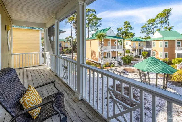 a living room with a flat screen tv and a view of kitchen