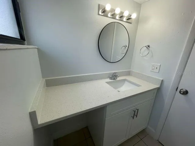 a bathroom with a sink and a mirror