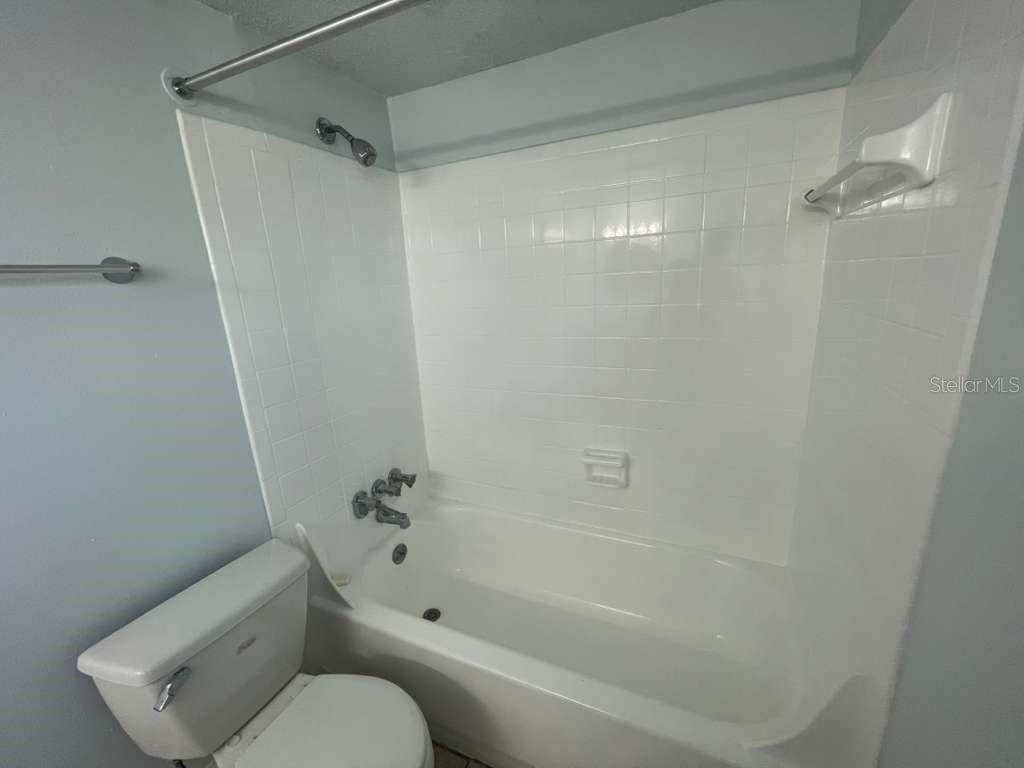 1108 Bartow Road, Unit D37 Lakeland, FL 33801 - Photo 8 of 16 a bathroom with a toilet and a shower