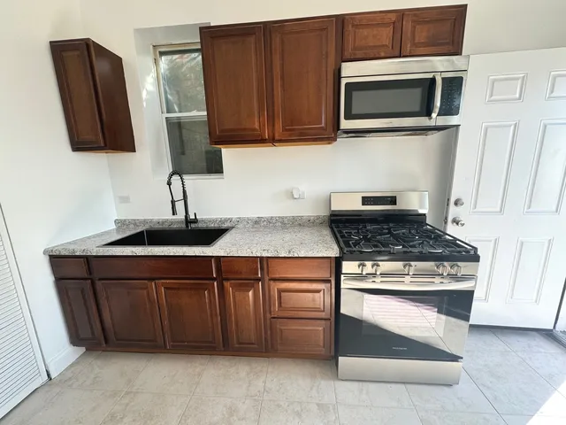 a kitchen with a stove and a microwave