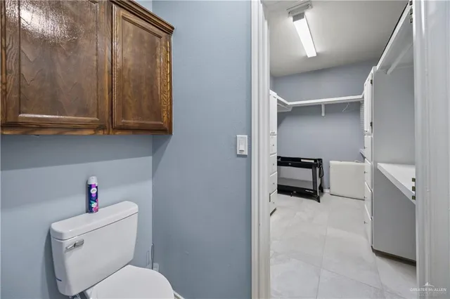 a bathroom with a granite countertop sink a large mirror and a shower