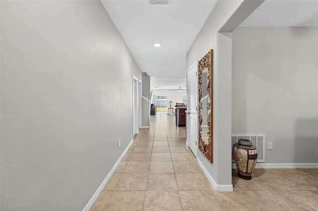 a view of a hallway with a kitchen