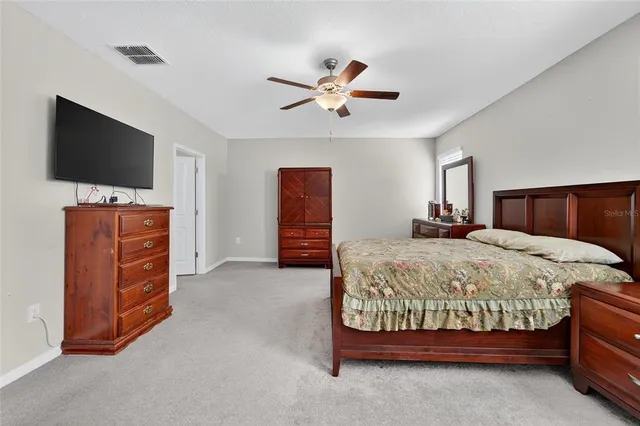 a bedroom with a bed and a flat screen television
