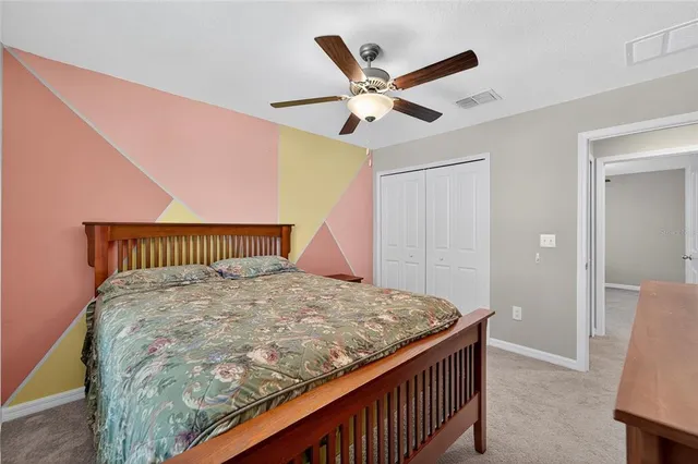 a bed sitting in a bedroom and a chandelier